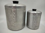 Two Vintage Mid Century Spun Aluminum Kitchen Canisters Sugar 8" & Tea 6". Fixed Price $14.45.