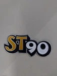 Honda ST90 Might Dax Yellow Aluminum Muffler Emblem Badge. Fixed Price $28.00.